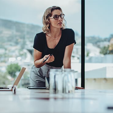 Businesswoman discussing work with coworkers in office