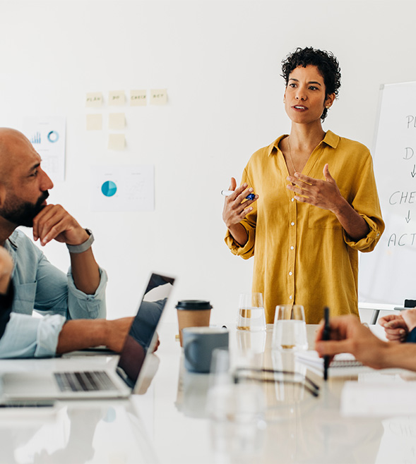 Business woman giving a speech during a boardroom meeting