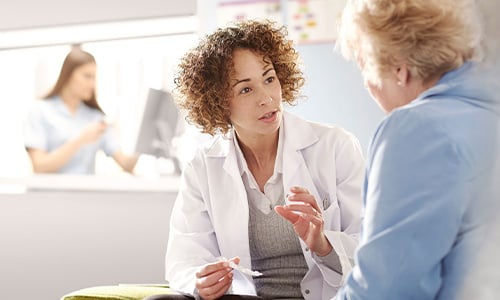 nurse speaking to a patient